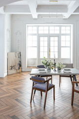 a view of a set dining table in a chic expensive bright interior of a huge living room in a...