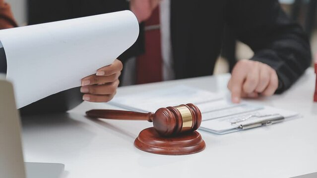 law concept The legal officer listening to the law report of booster and adjusting the agreement paper by writing it down.