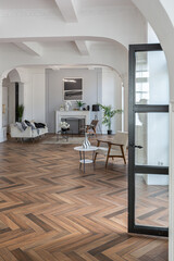 a chic expensive bright interior of a huge living room in a historic mansion with arched arches, columns and white walls decorated with ornaments and stucco.