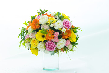 Many kinds of beautiful flowers put in vase on a white background