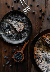 Rustic cake with blueberries on wooden table. Top view