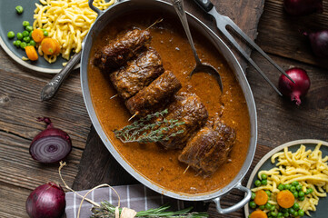 Beef roulades with gravy, spaetzle noodles and vegetables. Traditional german meat dish