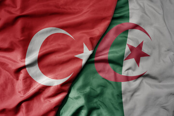 big waving national colorful flag of turkey and national flag of algeria .