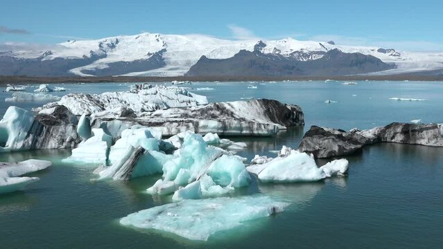 Global warming and climate change. Melting glacier in Iceland. Icebergs melt at turquoise ocean bay. Huge ice glacier at polar nature environment. Arctic winter landscape at global warming problem