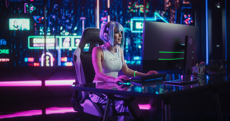 Young Woman Playing Online Video Game on a Computer in a Futuristic Digital World. Cosplay Girl with Blue Hair Streaming Futuristic Entertainment Content for Internet Fans