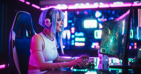 Fototapeta na wymiar Professional Beautiful Female eSports Gamer Playing 3D Strategy Video Game with Modern Graphics on Her Computer. Stylish Futuristic Cyberpunk Gaming Neon Room with Cosplay Gamer Girl in Headphones