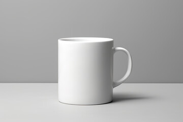 Fototapeta premium Close-up of a white mug with a handle on a gray background, a minimalist mockup