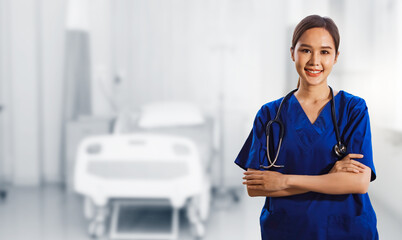 Portrait healthy asian female surgeon in blue dress with stethoscope standing crossed hands smiling...