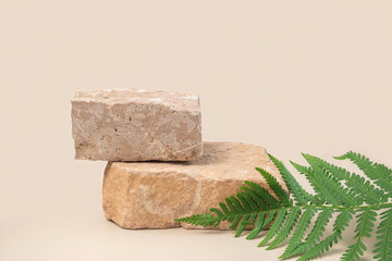 Stone Podiums for promotion on neutral beige Background. Natural stone pedestal. Green Palm fern leaves. Beauty product mockup. Cosmetics, Soap Stand. Showcase, display case. Soft shadow. Two Forms 3d