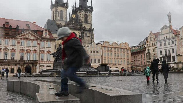 Child in the center of Prague, eating traditional czech dessert trdelnik in the city center
