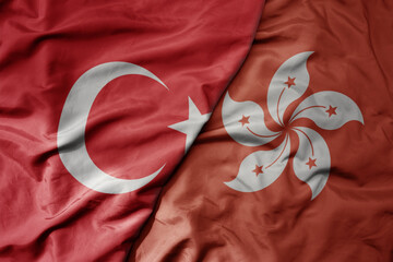 big waving national colorful flag of turkey and national flag of hong kong .