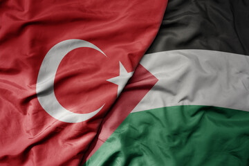 big waving national colorful flag of turkey and national flag of palestine .