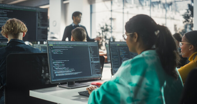 Portrait of a Teacher Giving Lesson to Diverse Multiethnic Group of Female and Male Students. Class Learning About Computer Science and Software Development. Lecturer Shares Knowledge with Scholars