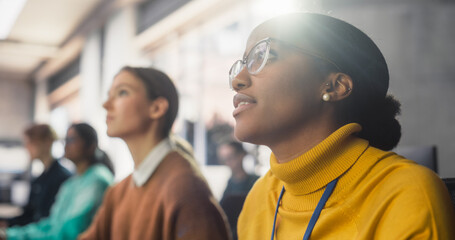 Portrait of a Bright Inspired Young African Female Student Studying in Modern University with Diverse Classmates. College Scholars Work in College Room, Learning IT, Programming or Computer Science