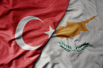 big waving national colorful flag of turkey and national flag of cyprus .