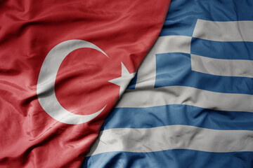 big waving national colorful flag of turkey and national flag of greece .