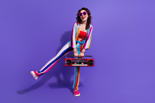 Photo of energetic lady enjoying have fun cassette retro boom box isolated on violet color background