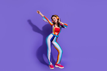 Photo of cheerful positive lady music lover use for listen stereo sound headset isolated on purple color background