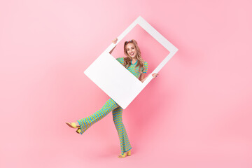 Full body photo of pretty young girl hold photo polaroid frame dance dressed stylish green print...