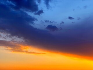 Dramatic Sunset sky clouds, orange blue dusk in heaven.