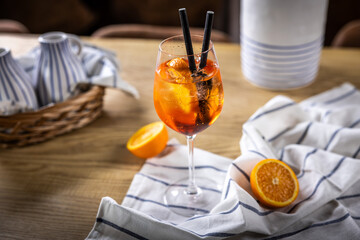 Glass of fresh Aperol Spritz on the table with oranges
