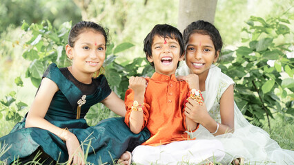 celebrated in India as a festival denoting brother-sister love and relationship. Two sister are binding rakhi on her brother hand on the festival of raksha Bandhan