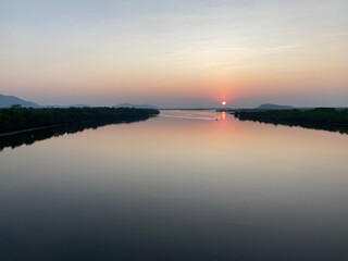 Sunset behind a river on the beautiful Konkan Railway coastal route in Western India.