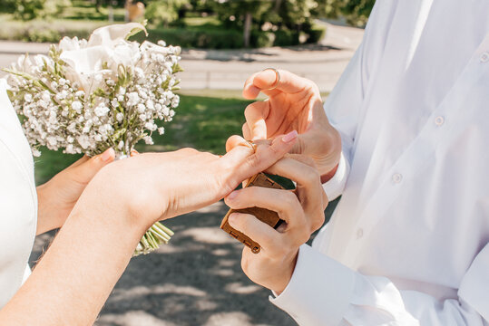Picture of man and woman with wedding ring.Young married couple holding hands, ceremony wedding day. Newly wed couple's hands with wedding rings.