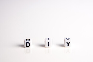 diy word or concept made by white letter cubes on white and gray background, do it yourself...