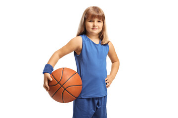 Girl in a blue sports jersey holding a basketball and smiling at camera