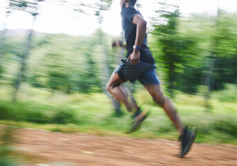 Sports man, speed and running in forest with motion blur, cardio workout and exercise action....