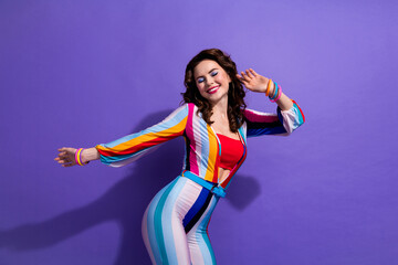 Photo of funky dreamy lady wear striped overall having fun enjoying discotheque isolated purple...