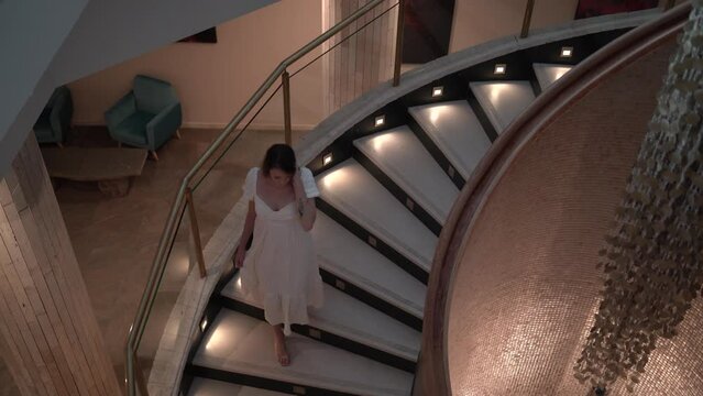 Planos en 4k de chica joven en hall de hotel dando un paseo y mirando a camara