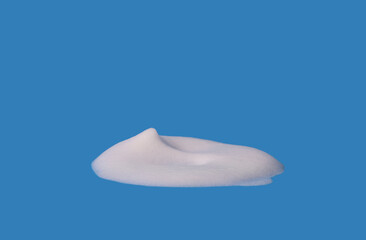  Foam texture, white bubbles from soap or shampoo or shower gel and facial foam. isolated on blue background