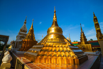 Fototapeta premium Pagoda gold and church in wat thai reflect with sun sky in day time in Bangkok Thailand.