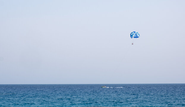 Tourist people parasailing in the sea. Summer  entertainment holidays, extreme sports outdoor