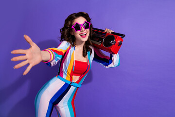 Photo of shiny excited girl dressed striped overall listening boombox disco music empty space...