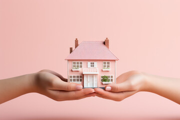 Fototapeta na wymiar Hand holding house model isolated on pastel background with copy space, house finance and insurance concept