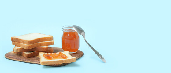 Tasty toasts and apricot jam on light blue background with space for text