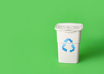Container for garbage on green background. Recycling concept