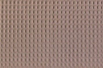 The texture of natural cotton fabric is brown. Simple coarse fabric, homemade soft cotton napkin. The usual background of a duster.