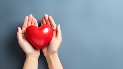 Fototapeta premium hand holding red heart, love passing