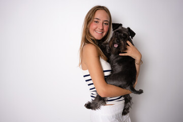 Positive female with glad expression and her dog being satisfied after walk outdoor, have good relationships, isolated over white background. Domestic animals and people.