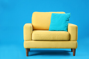 Yellow armchair on blue background