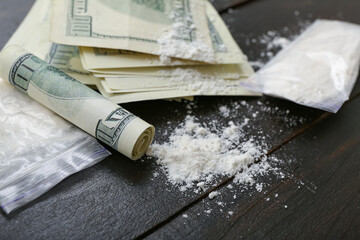 Drugs and money on dark wooden background, closeup