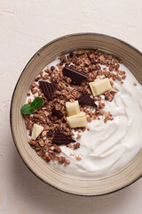yogurt with chocolate muesli, breakfast, close-up, fork on top, no people,