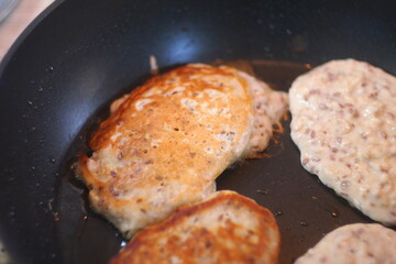 pancakes in a pan. Frying Pan On The Stove. Pancake Burned On The Pan. Mans Hand Turns The Pancake To The Other Side. He Lingers When He Sees That The Pancake Has Burned.