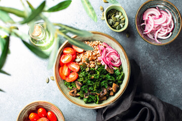 Kale and mushrooms vegan bowl, overhead view