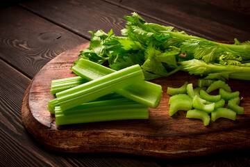 fresh bunch of celery, top view, no people, on a dark background,
