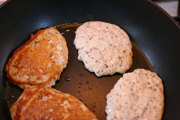 pancakes in a pan. Frying Pan On The Stove. Pancake Burned On The Pan. Mans Hand Turns The Pancake To The Other Side. He Lingers When He Sees That The Pancake Has Burned.